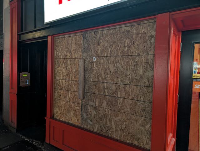 Restaurant window secured with emergency board-up